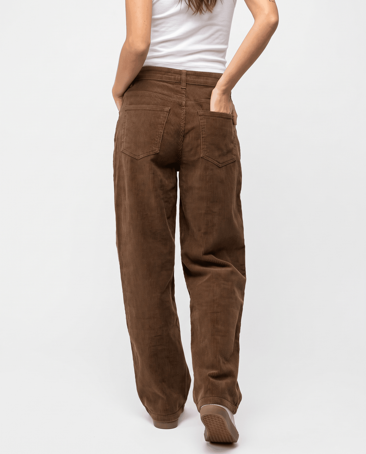 Back view of relaxed brown corduroy pants with patch pockets and a full-length hem