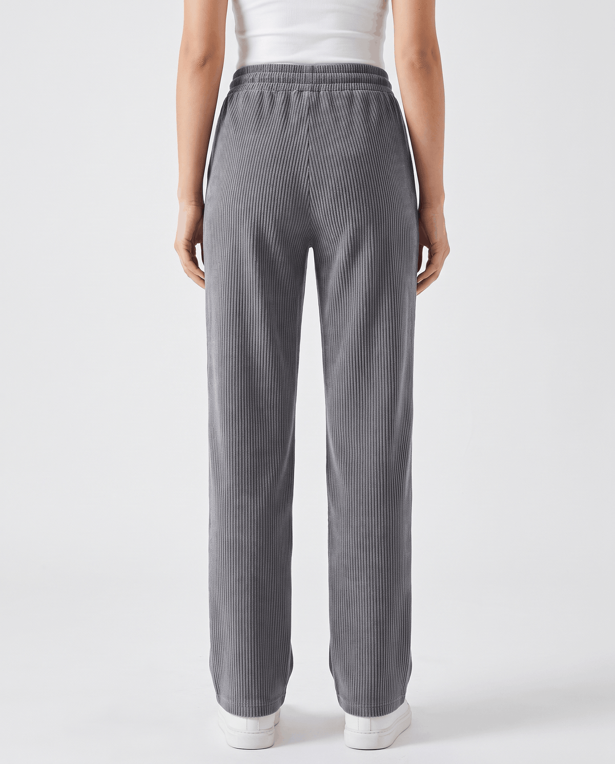 Back view of gray ribbed trousers showing the elastic waistband and straight wide leg