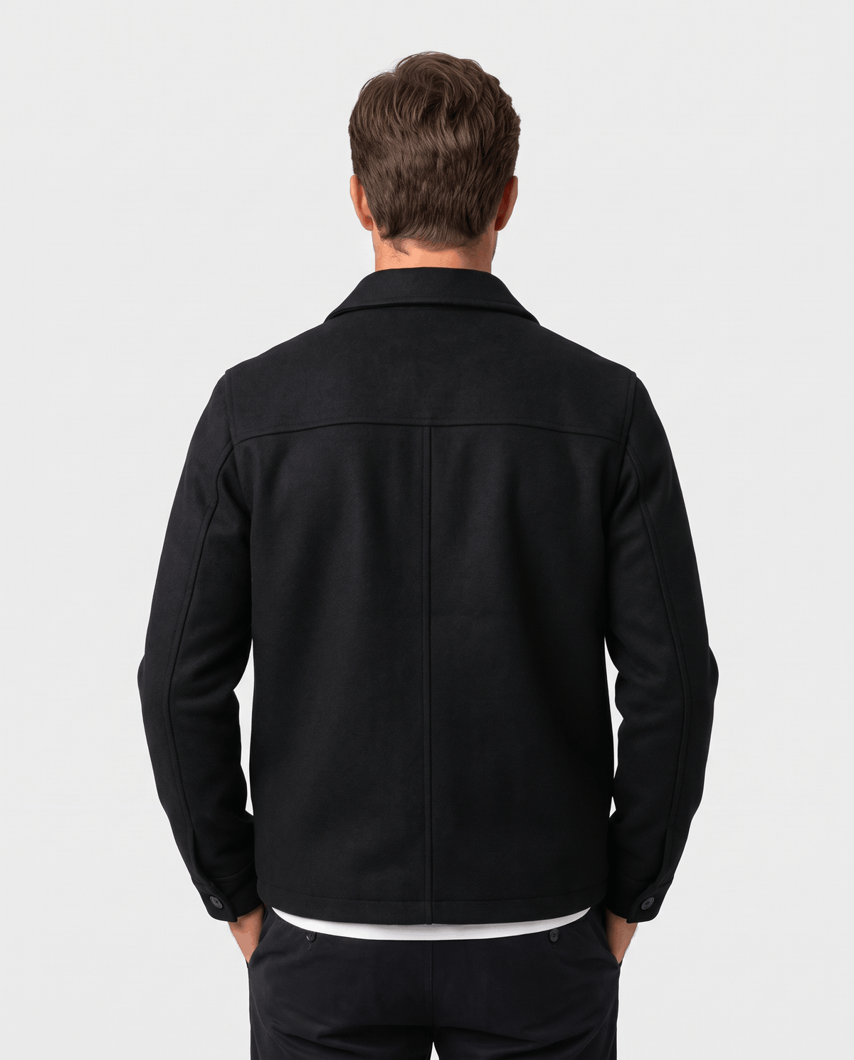Back view of the black jacket showing the plain yoke and straight hem
