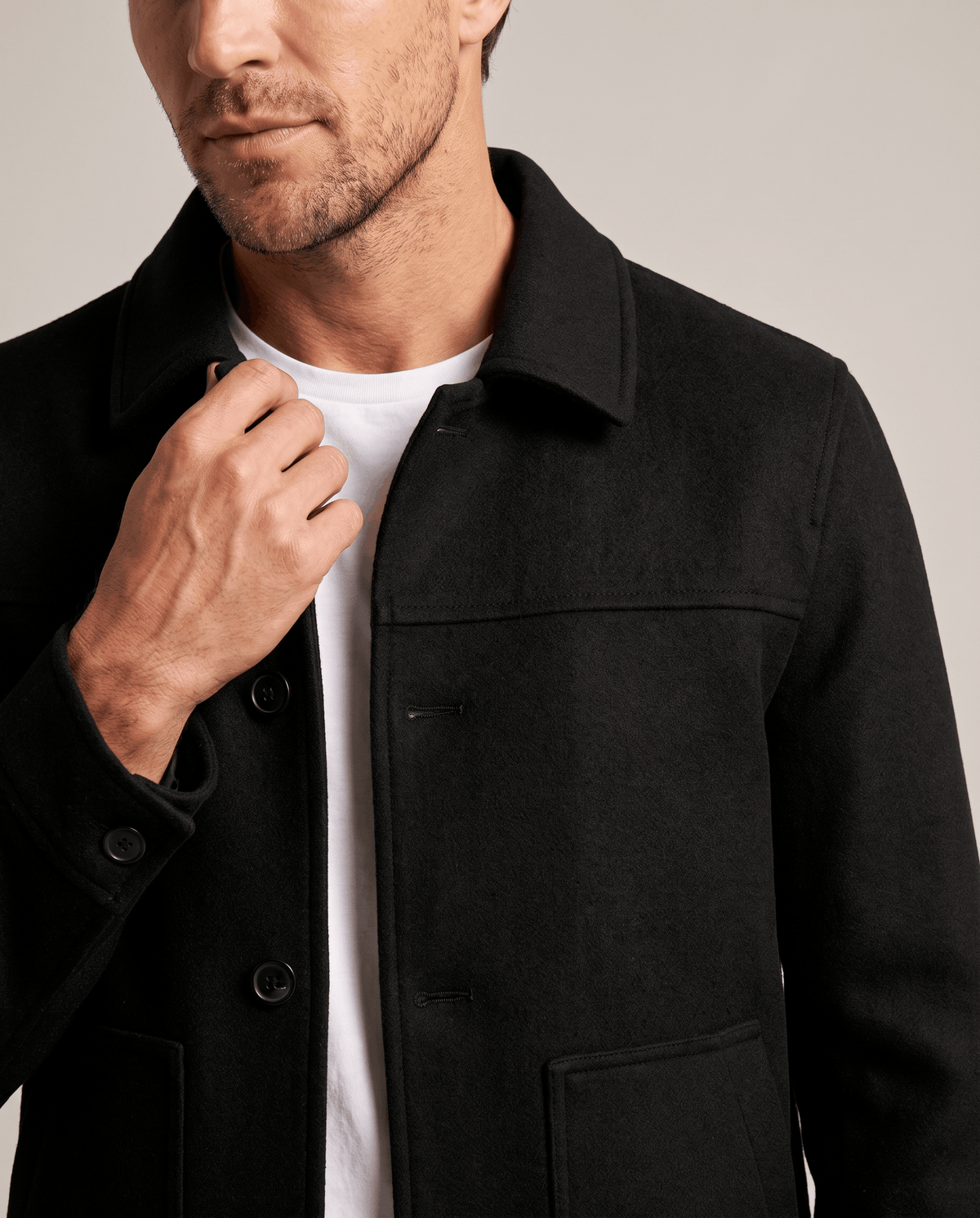 Close crop of the black brushed fabric at the collar and shoulder seam