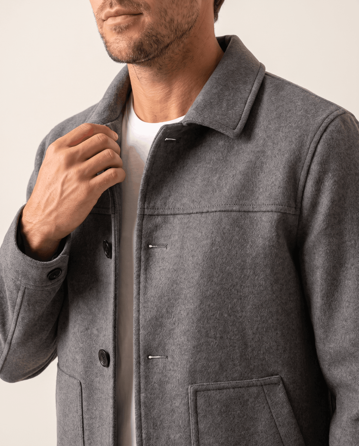 Gray jacket front detail showing the button placket and patch pocket placement