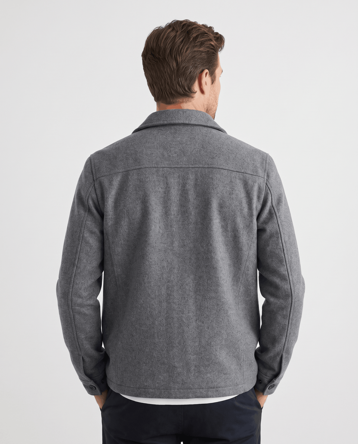 Model in a gray jacket turned slightly, showing the sleeve line