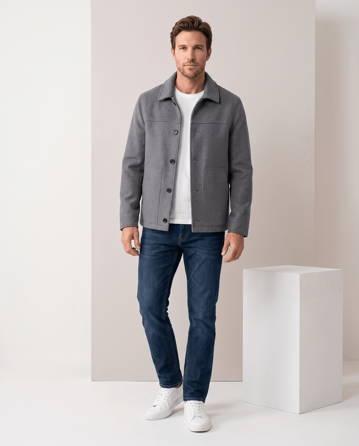 Gray jacket worn with the collar up against the neck outdoors