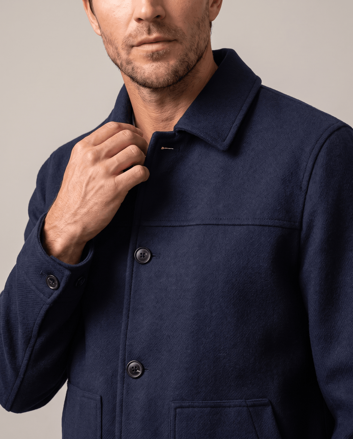 Navy jacket front detail with the buttons fastened to the point collar