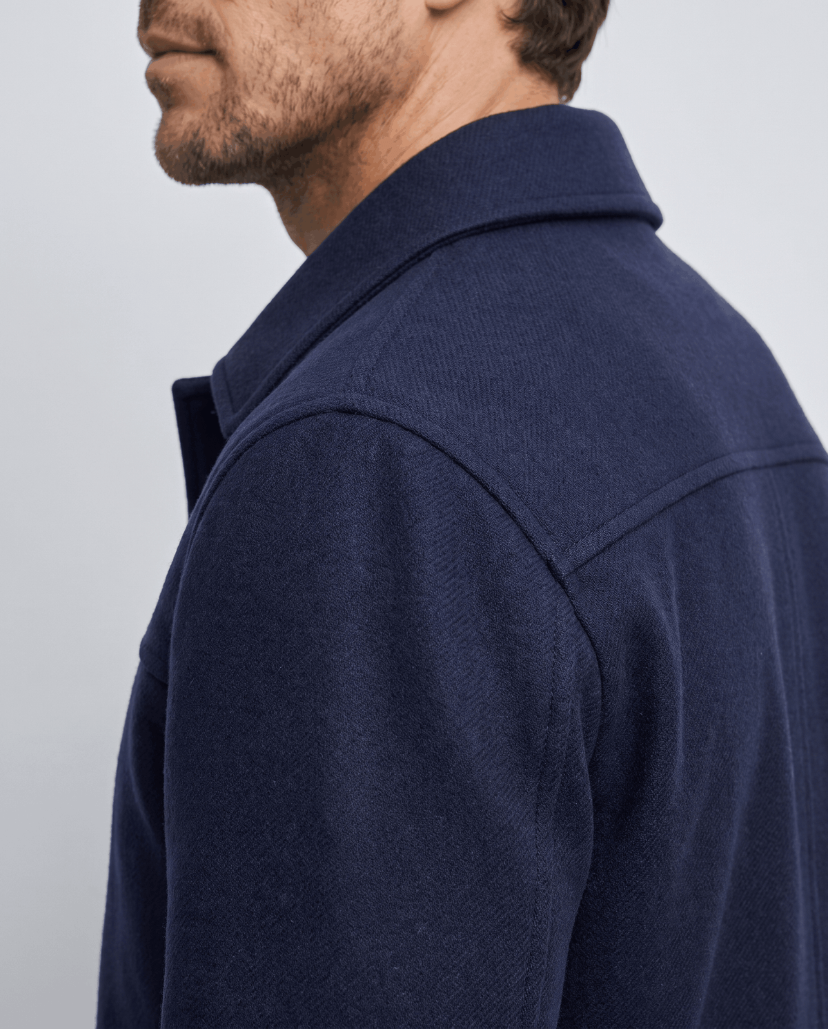 Close view of the navy brushed fabric and the collar seam