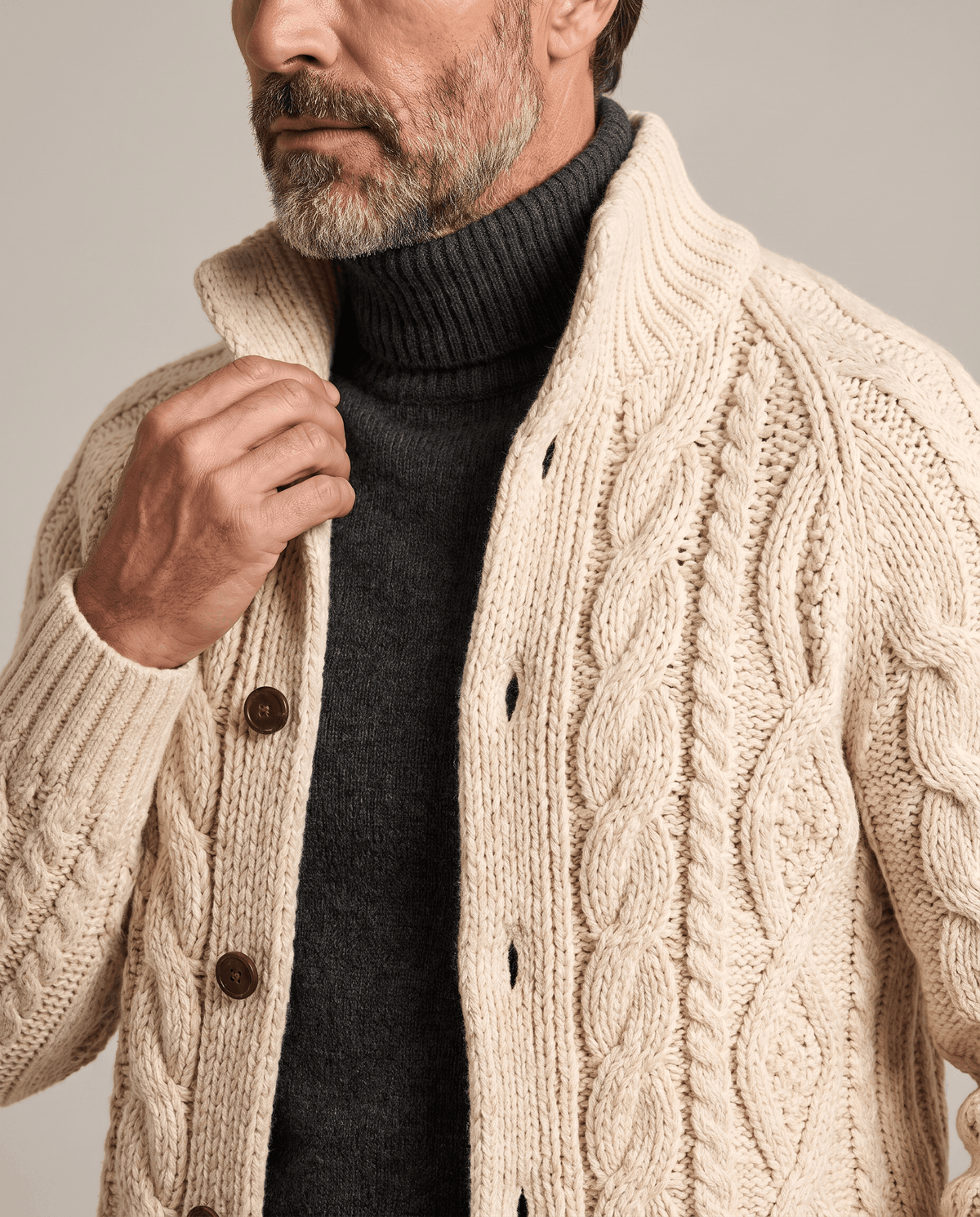 Beige cable knit cardigan buttons and chunky cables shown in close view