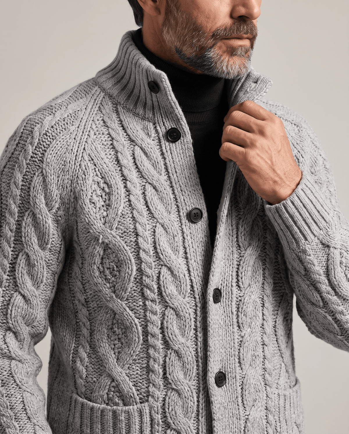 Gray cable knit cardigan stand collar and buttons shown in close view