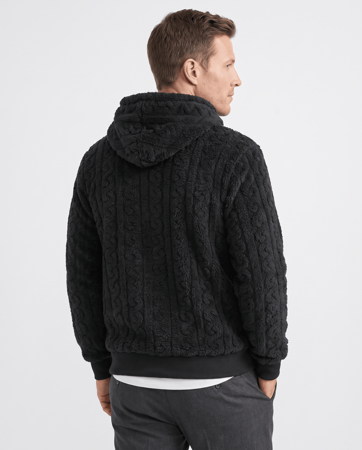 Back of black hoodie with hood resting on the shoulders and cable texture