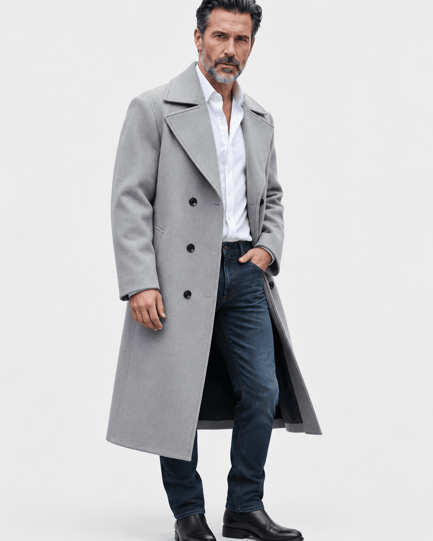Light gray long overcoat in a three-quarter view with one hand in a jeans pocket
