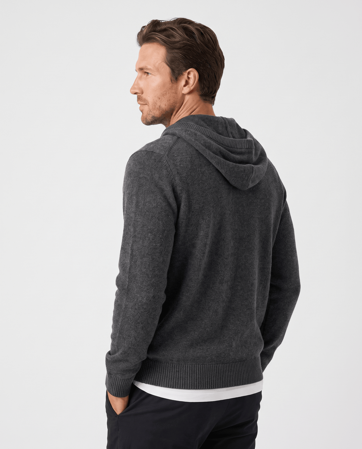 Back view of a dark gray knit pullover hoodie with a soft drawstring hood