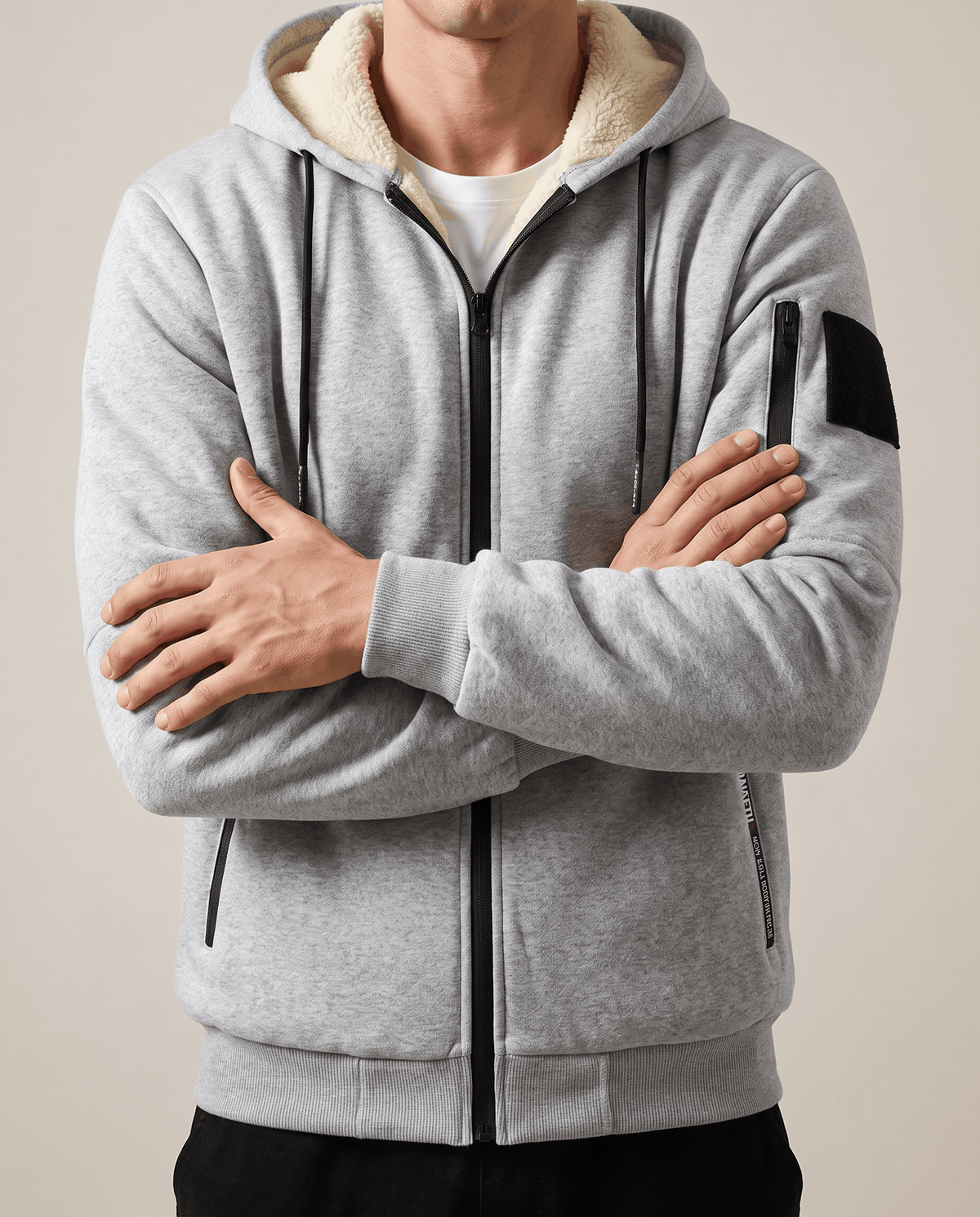 Gray jacket worn zipped with arms crossed, showing the cream fleece lining at the hood