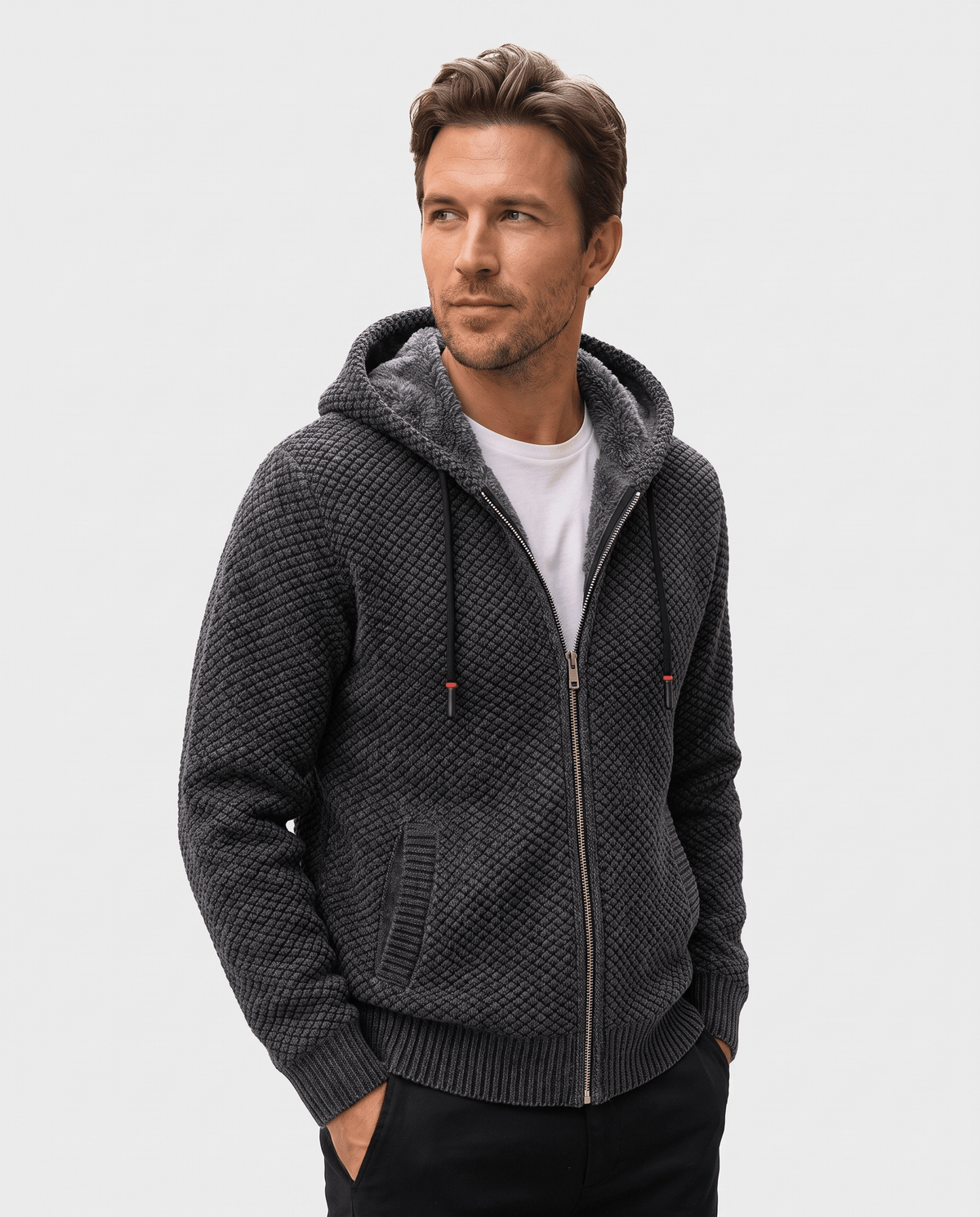 Man wearing a dark gray waffle knit zip hoodie with a fleece-lined hood, front view