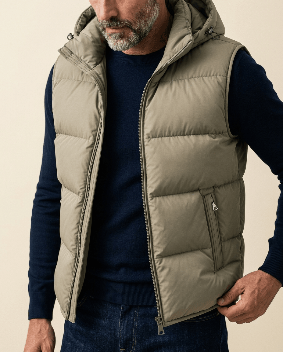 Close-up of beige quilted vest with hood open, showing zip pocket and padded channels