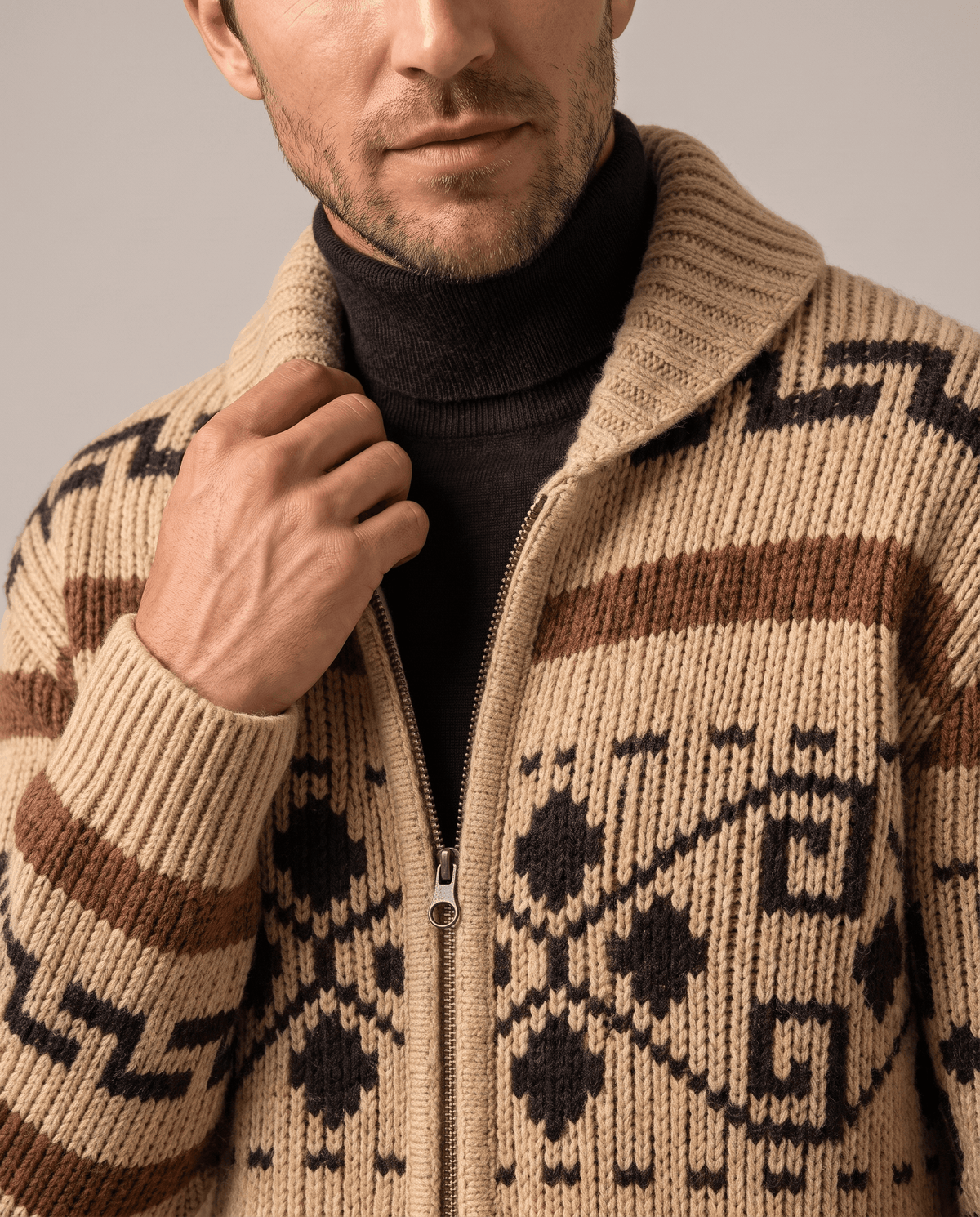 Khaki zip cardigan over a black turtleneck, close view of geometric jacquard knit