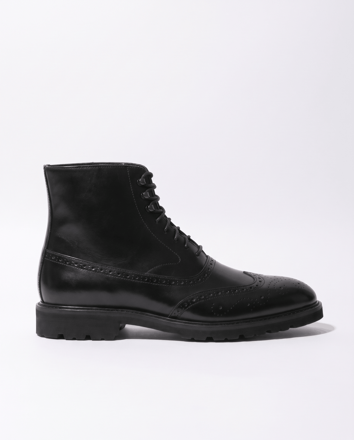 Black smooth leather ankle boot in profile on a plain light background