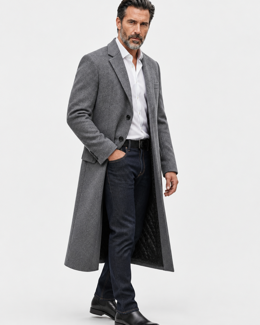 Gray long overcoat in a three-quarter view, worn open with one hand in a pocket and the lining showing