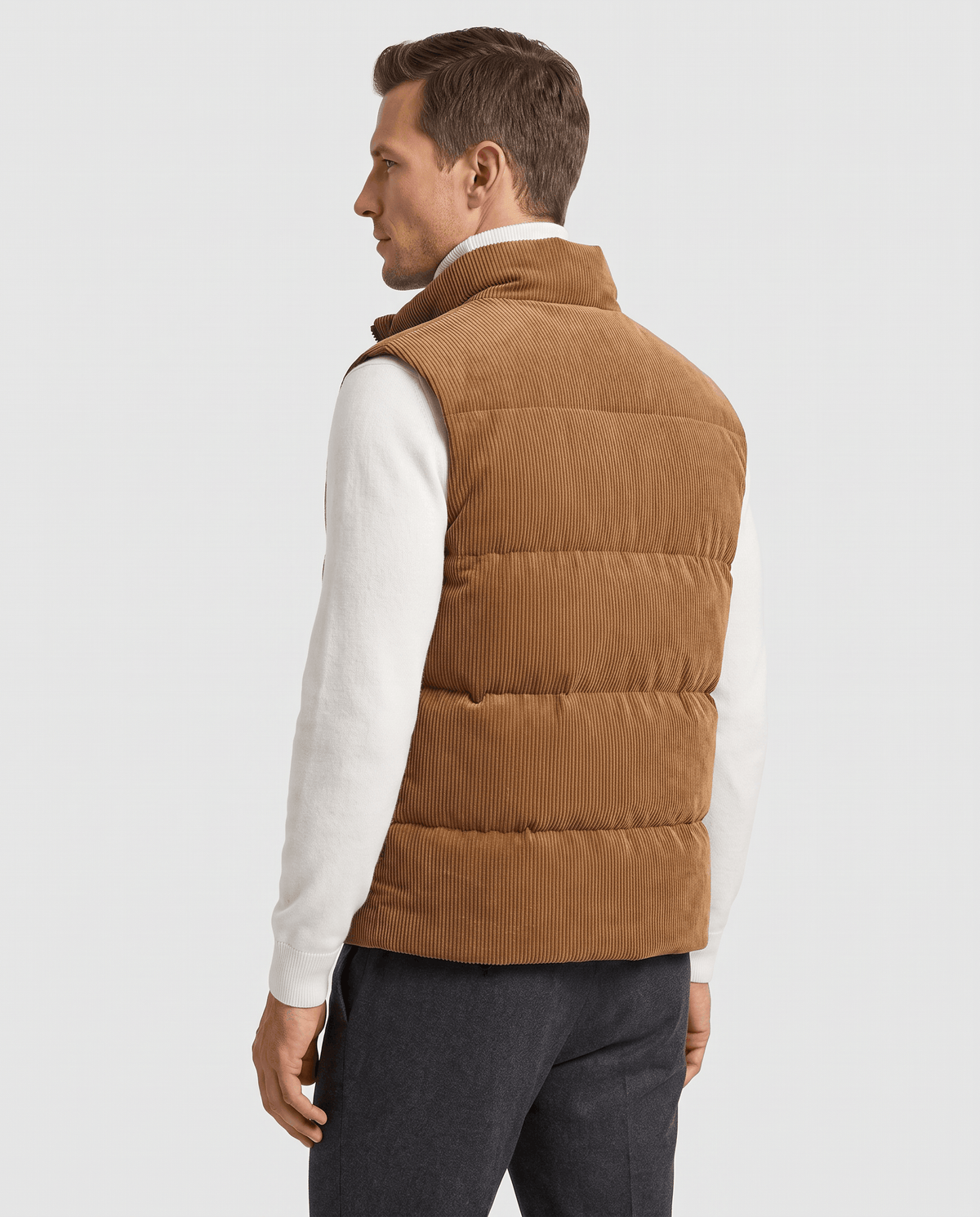 Back view of brown corduroy vest with quilted panels over a white sweater