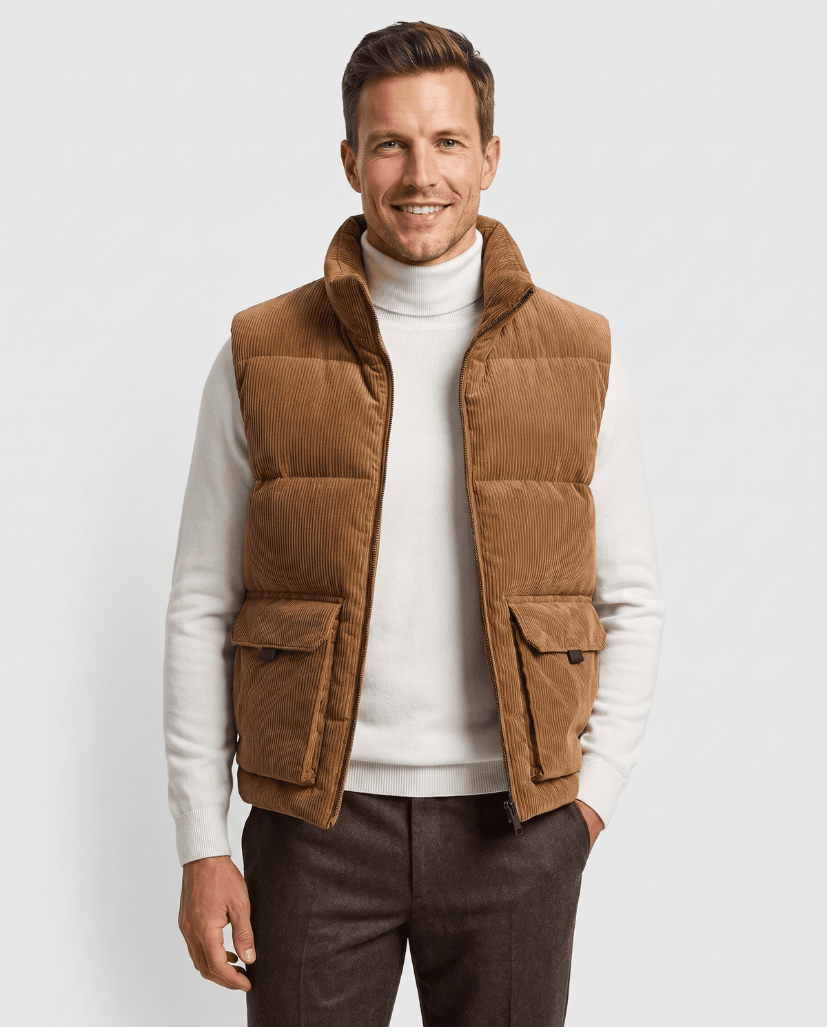 Men's padded corduroy vest in brown with front flap pockets over a white turtleneck