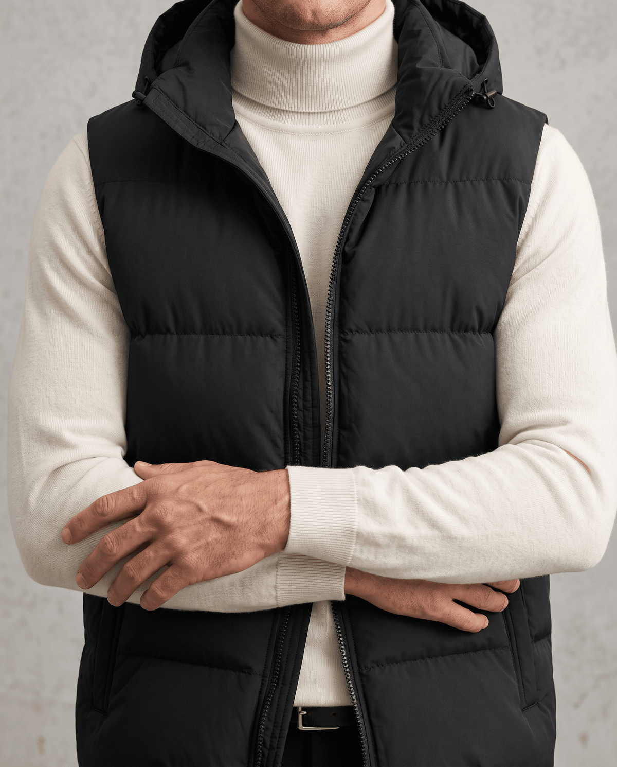 Black padded vest with arms crossed showing horizontal padded panels