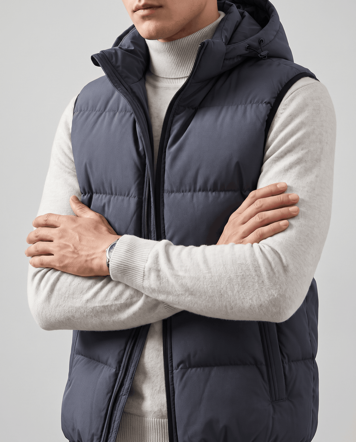 Blue-gray padded vest with arms crossed showing horizontal padded panels