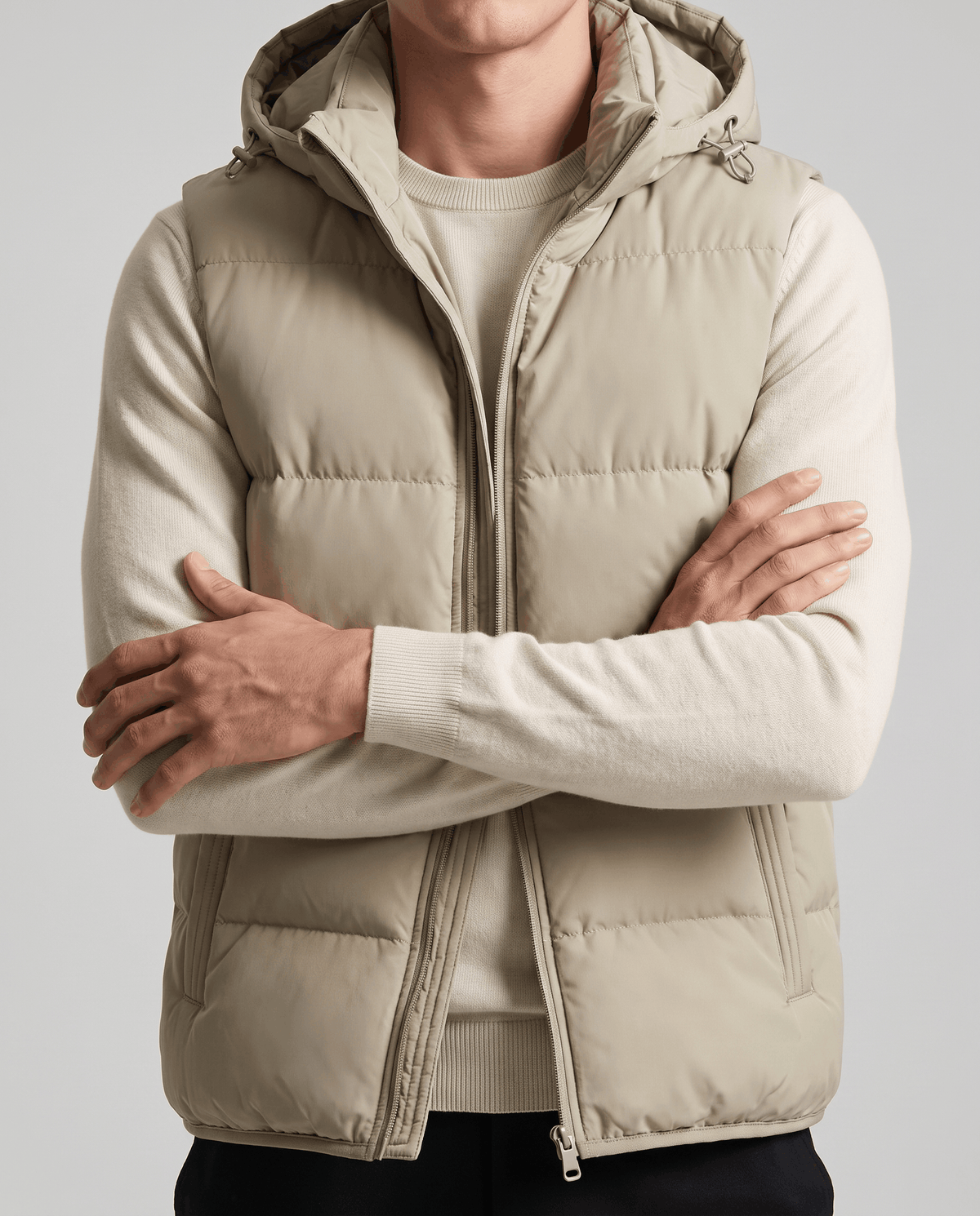 Khaki padded vest with arms crossed showing horizontal padded panels