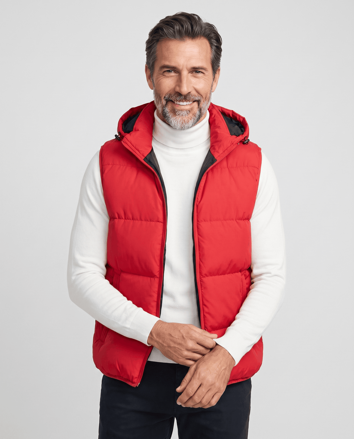 Men's red padded hooded vest worn over a white turtleneck