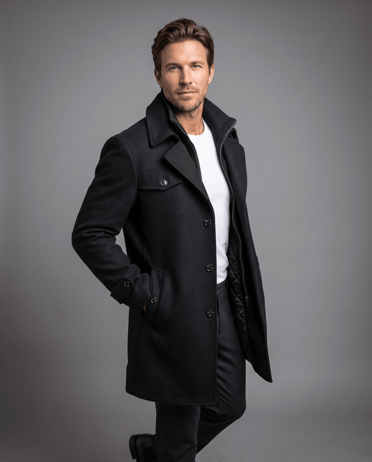 Men's quilt-lined wool overcoat in black with a double collar, worn over a white tee