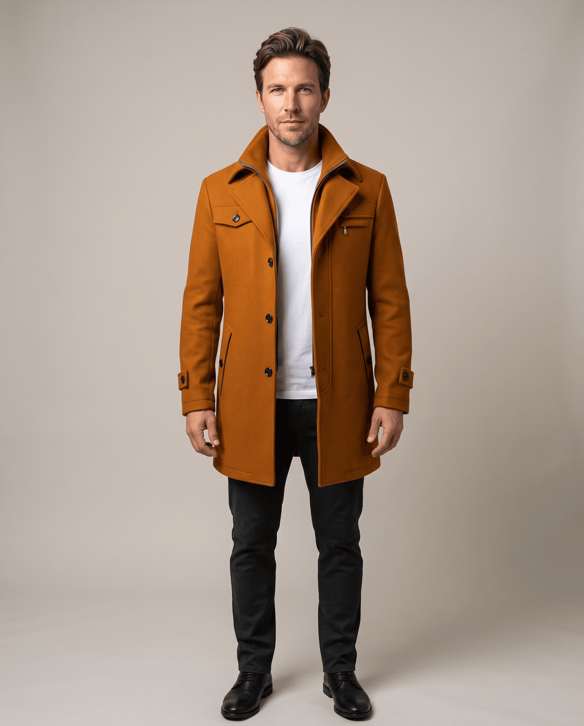 Front view of the brown overcoat buttoned over a white tee and dark trousers