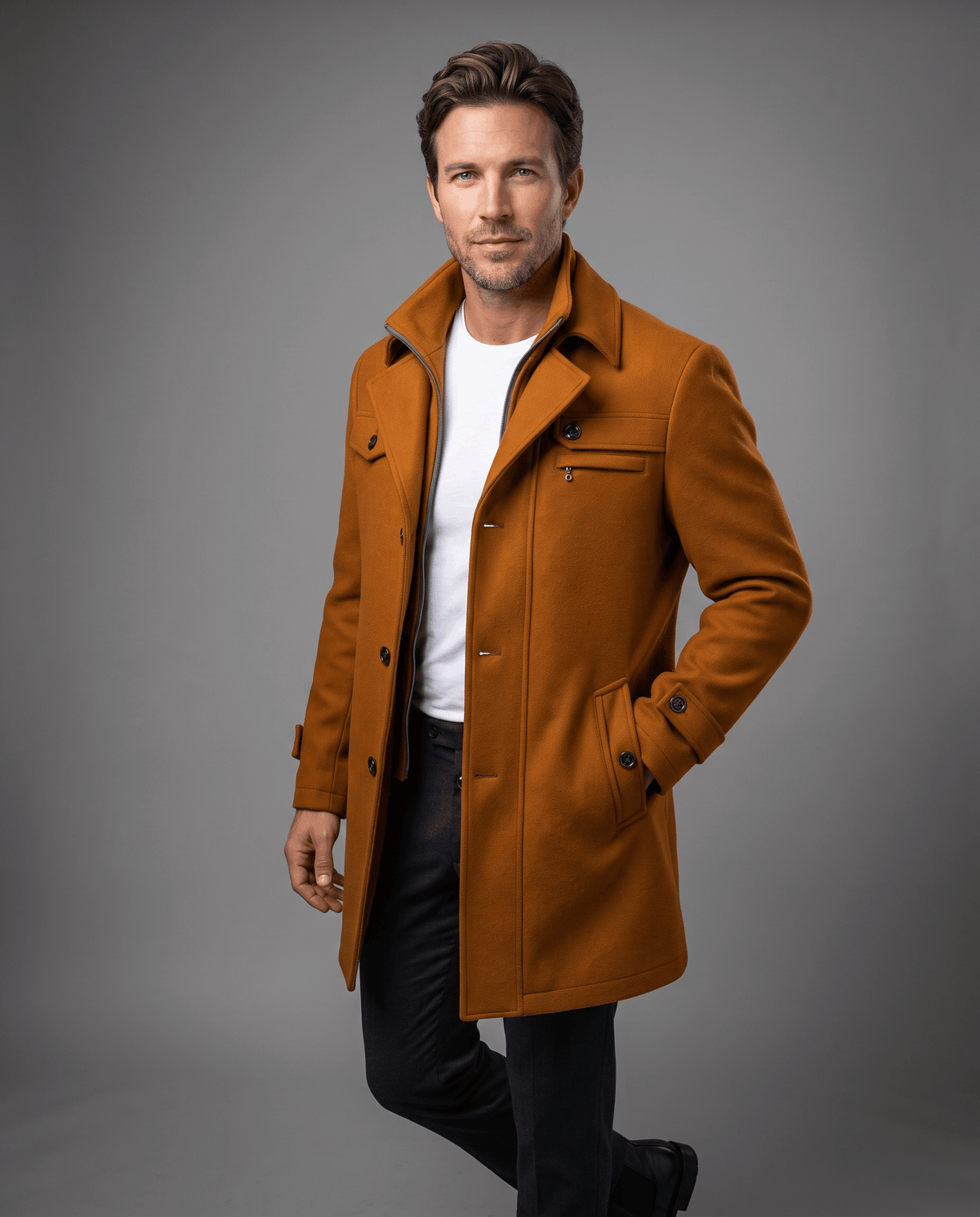 Brown overcoat with a double collar and chest pockets, worn with one hand in a pocket