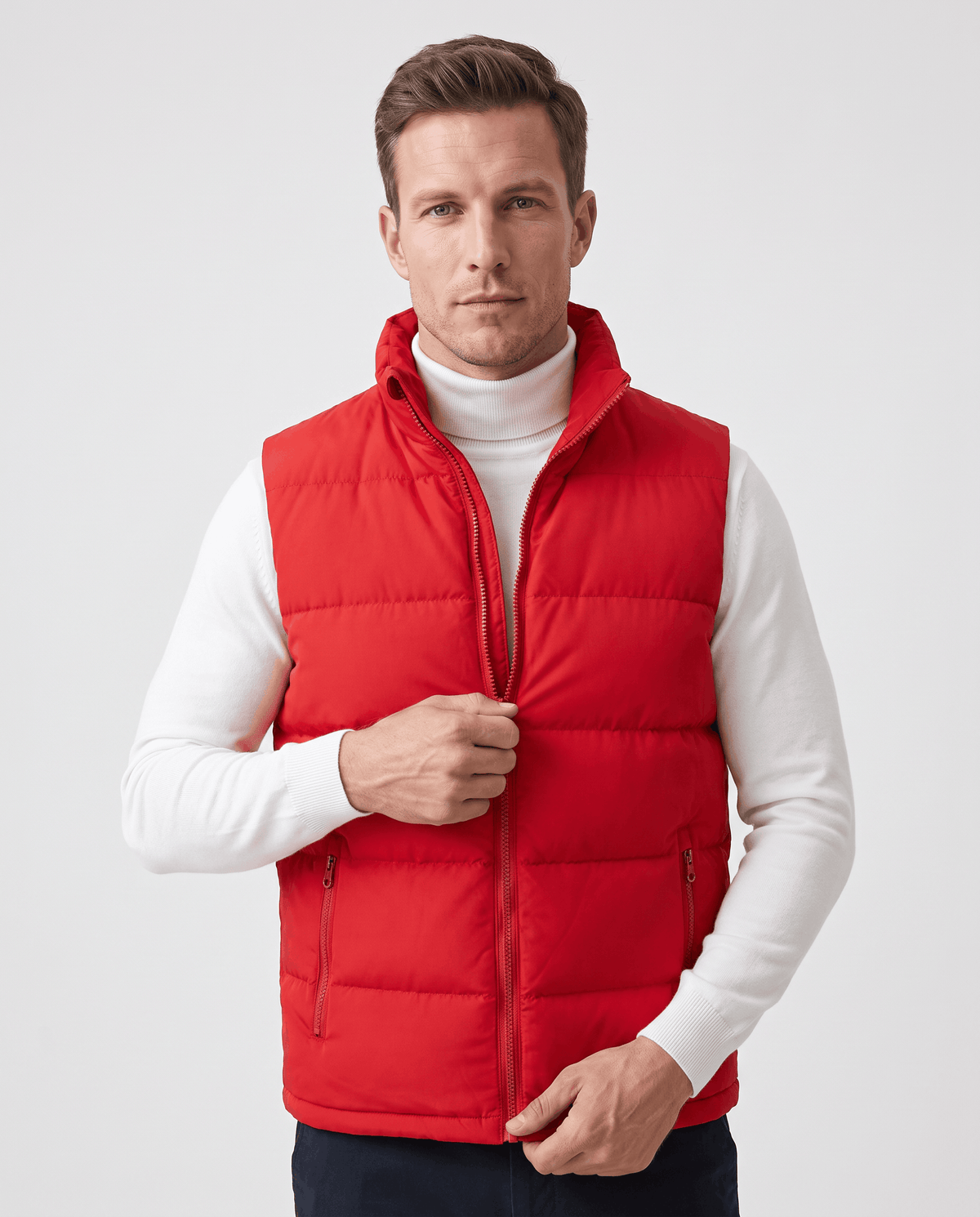 Red quilted vest zipped over a white turtleneck, one hand at the front