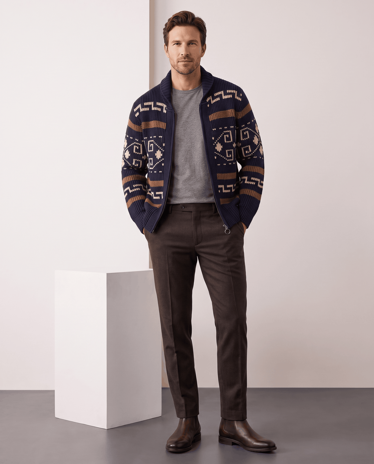 Full-length look with navy blue jacquard cardigan, brown trousers and brown shoes