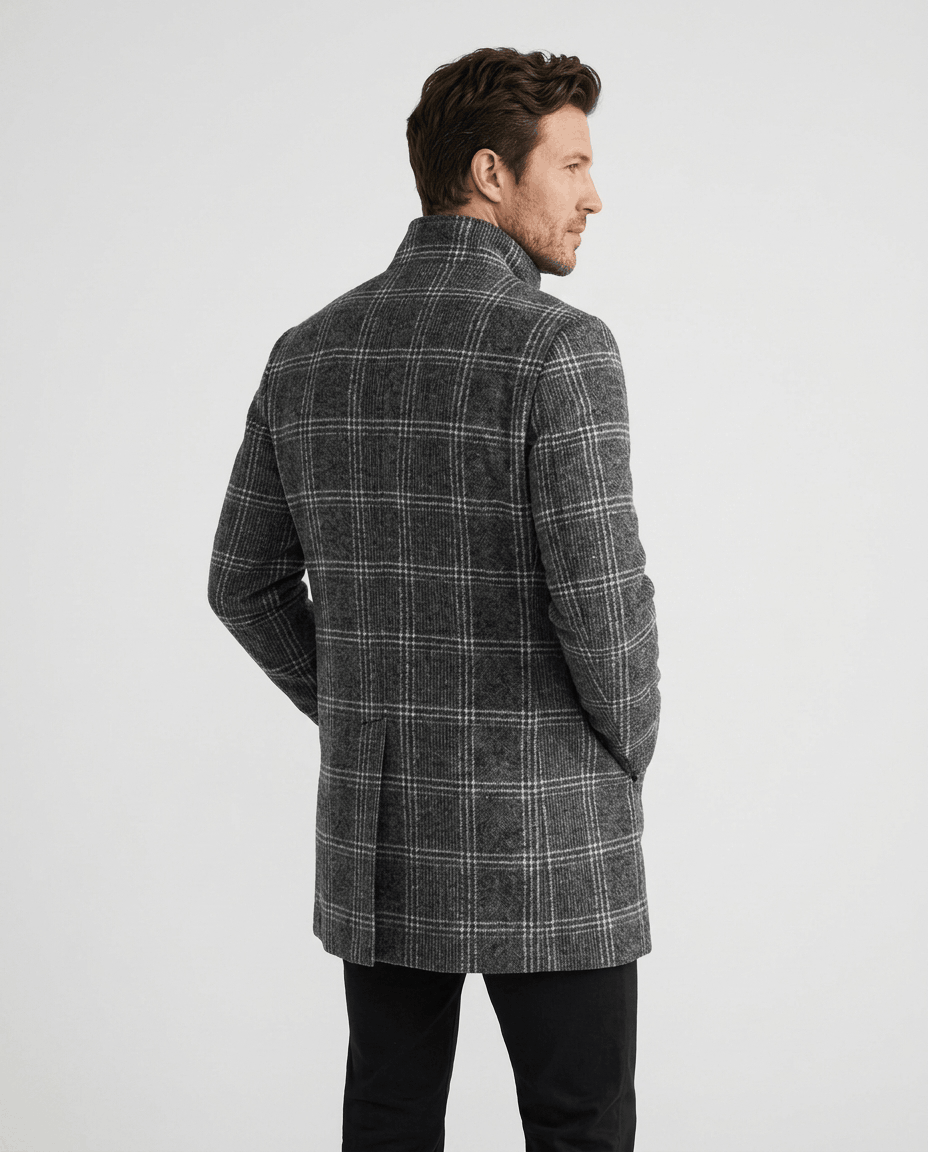 Back view of the dark gray check overcoat worn with black trousers