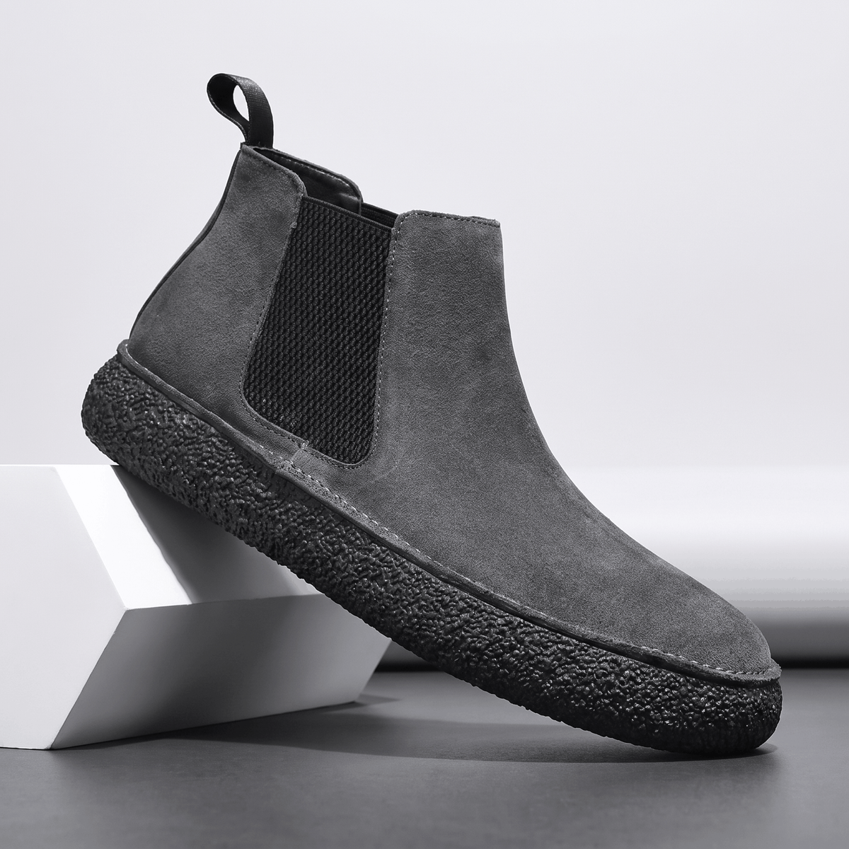 Gray suede Chelsea boot with elastic side panel, pull tab and thick speckled crepe sole.
