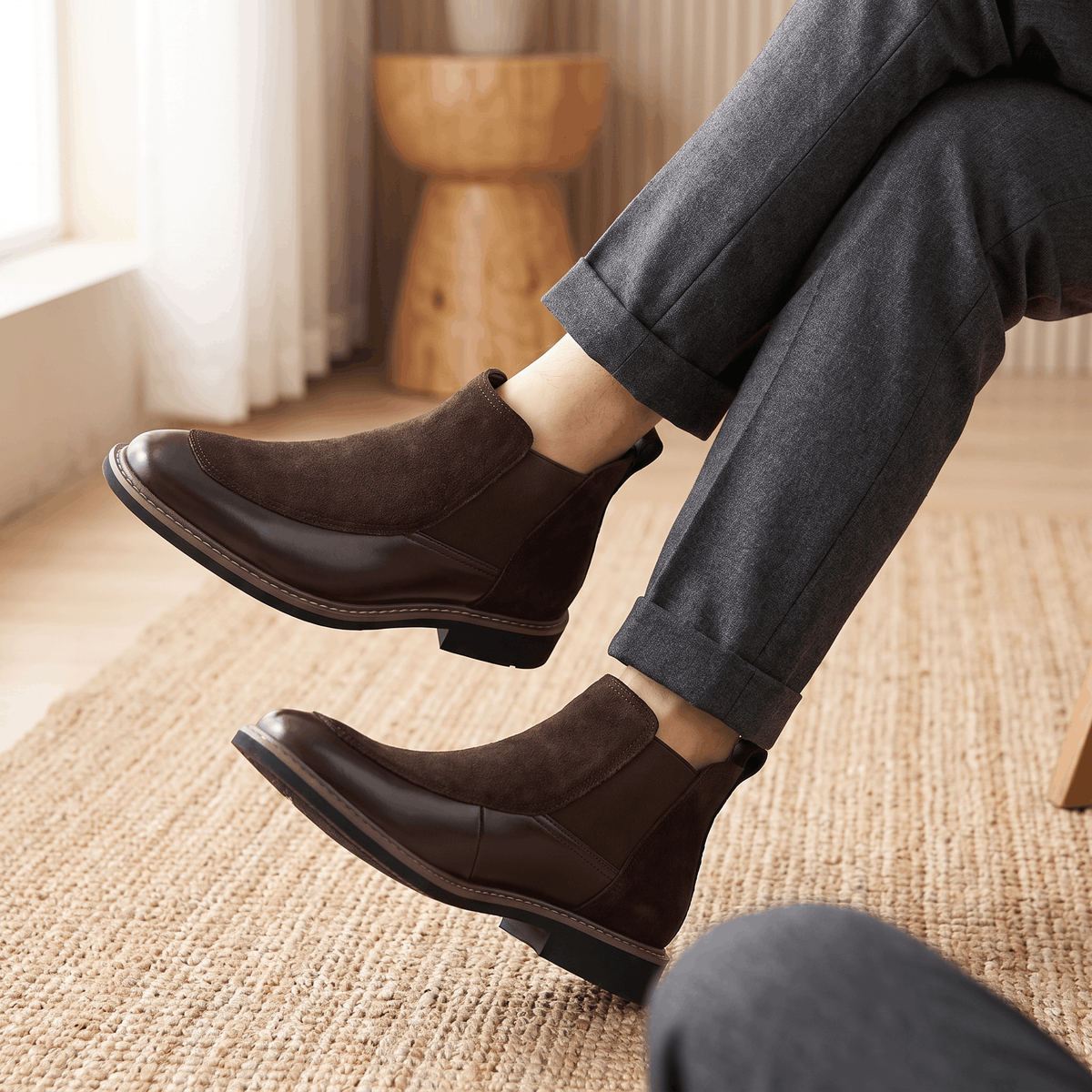 Dark brown suede and polished leather Chelsea boots with elastic side gores, welt stitching, and a stacked heel.