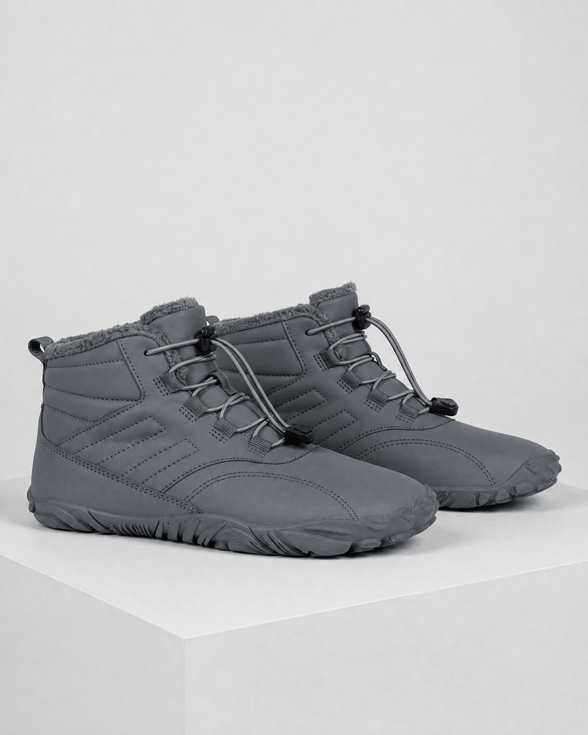 Gray water-repellent winter ankle boots with a fleece-lined collar, flexible rubber sole, and bungee lace toggle system.