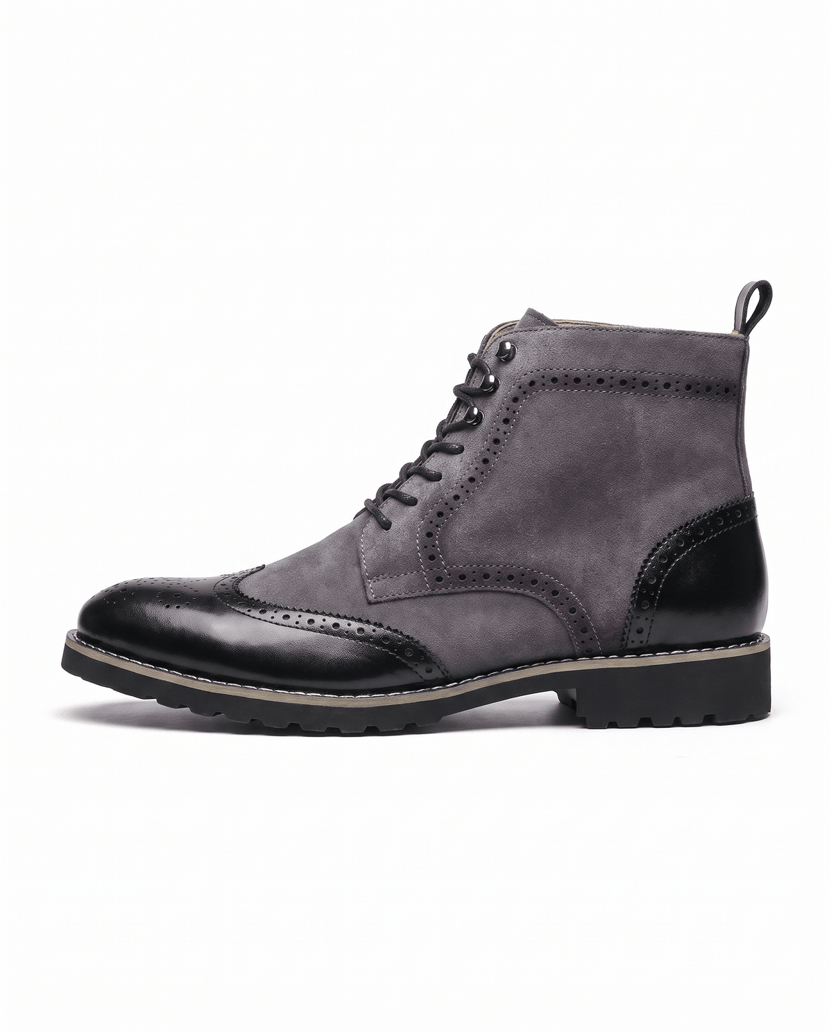 Side view of a gray suede ankle boot with a black brogue wingtip toe cap