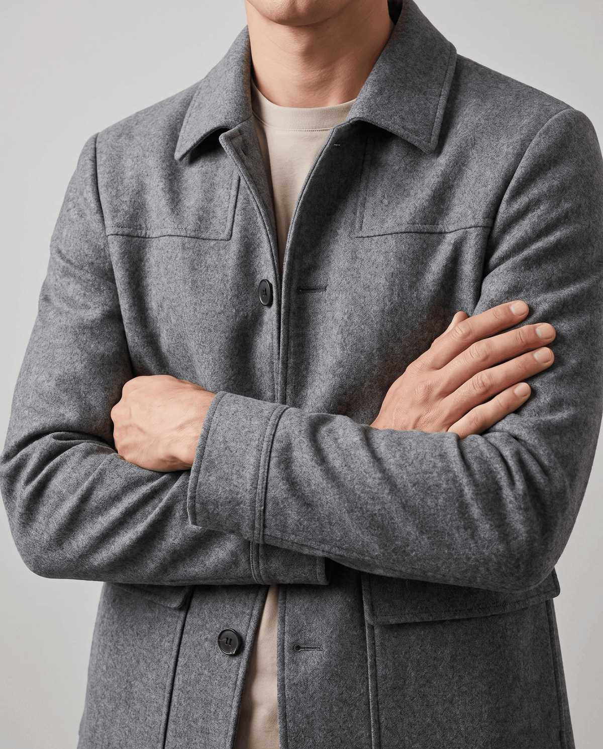 Close crop of the gray coat across the chest with arms folded