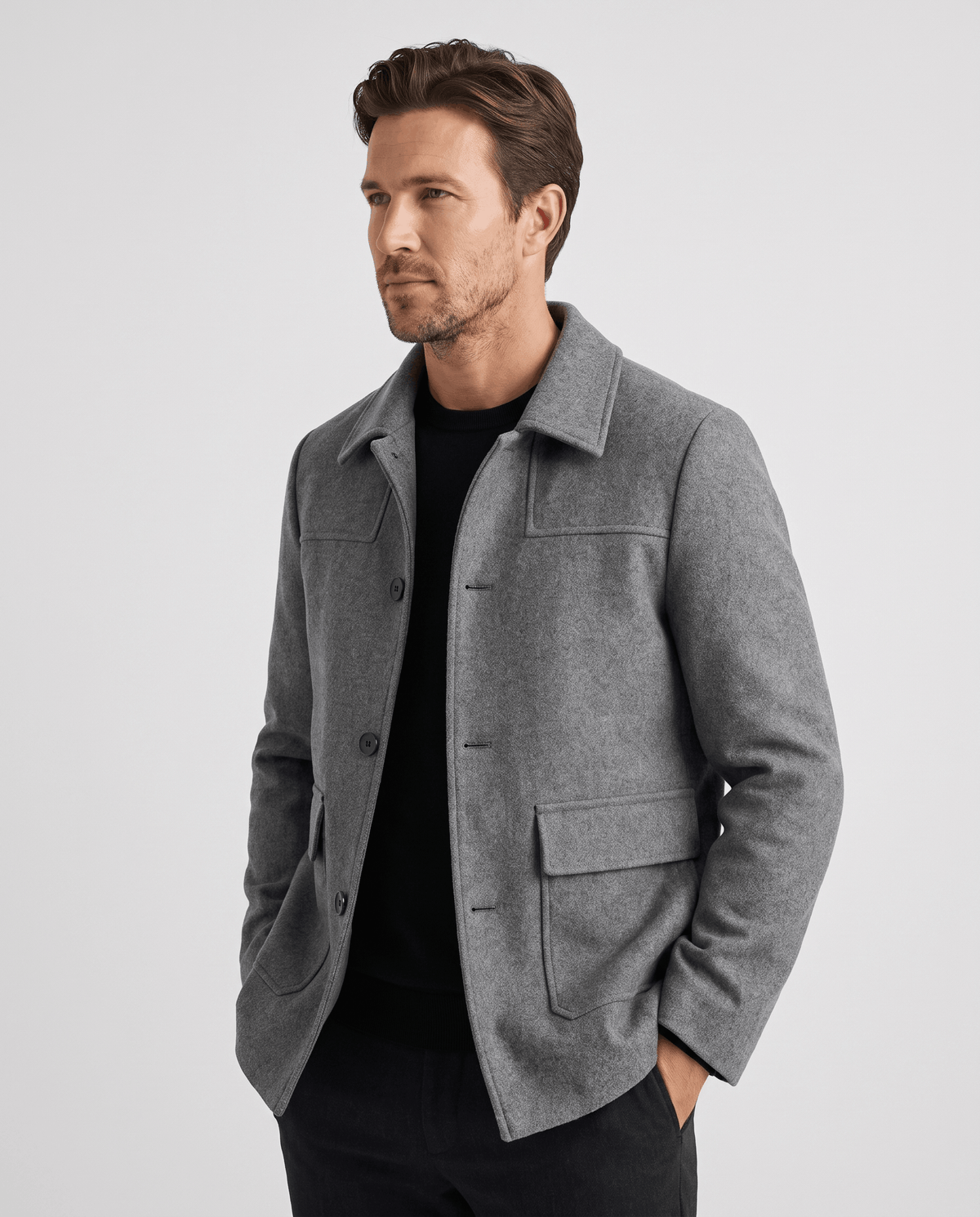 Gray car coat worn open with both hands resting in the flap pockets