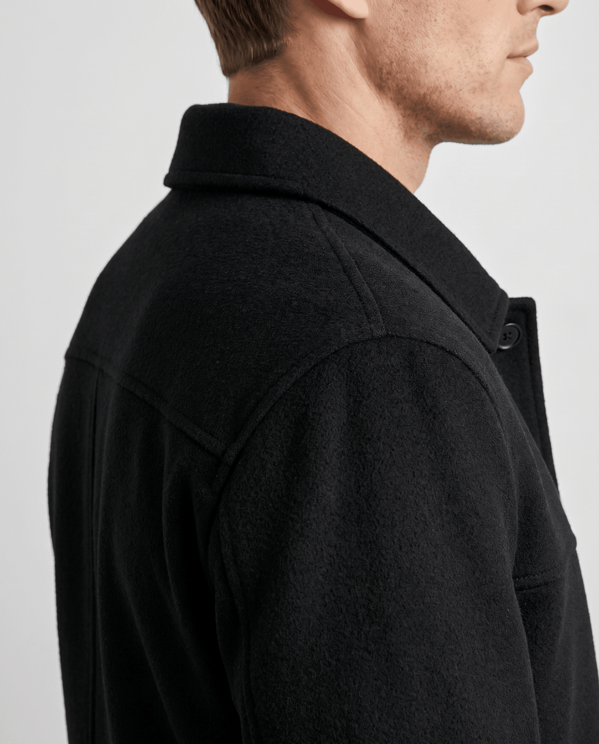 Shoulder and yoke seam close-up on a black double-faced wool-blend jacket