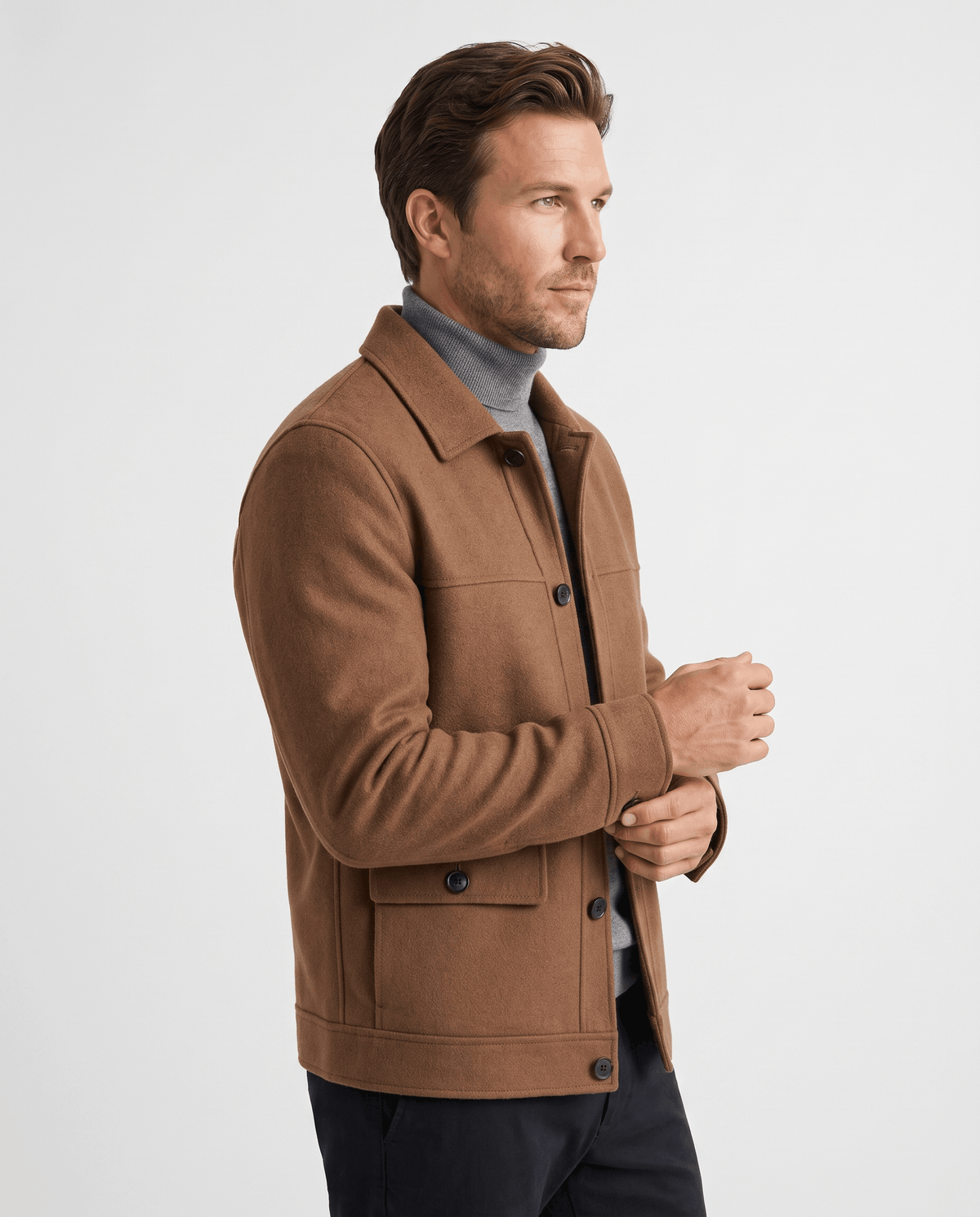Side view of a camel double-faced jacket showing the flap pocket and sleeve seam