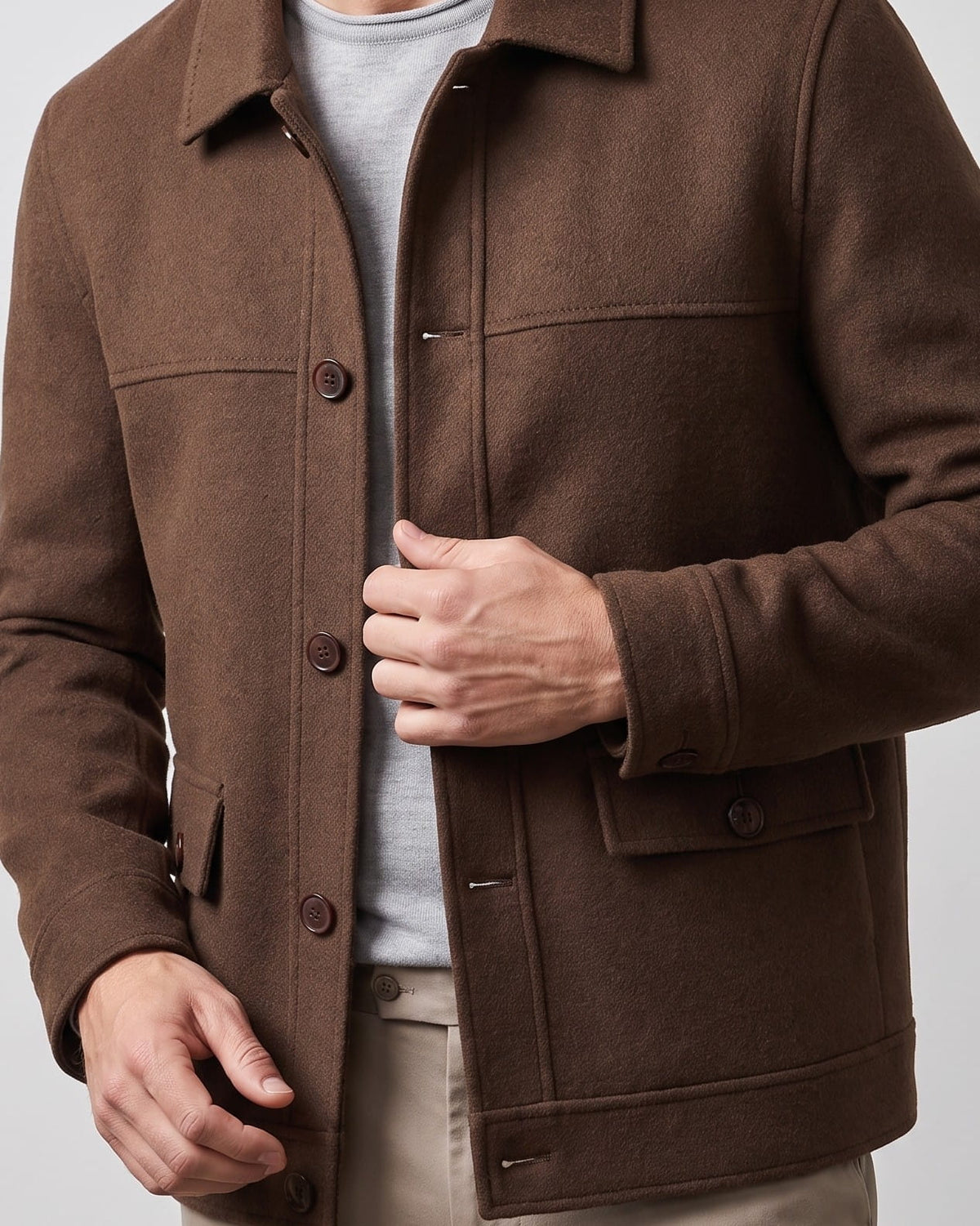 Dark brown jacket chest detail showing the welt hand pocket and flap pocket