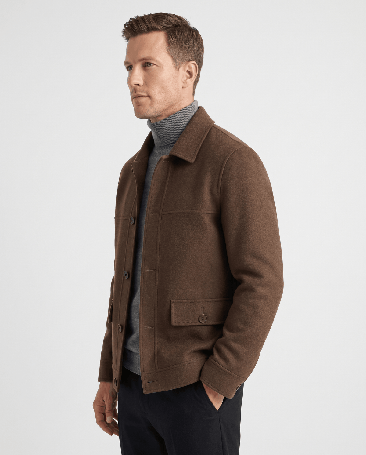Three-quarter view of a dark brown jacket with the buttoned cuff tab visible