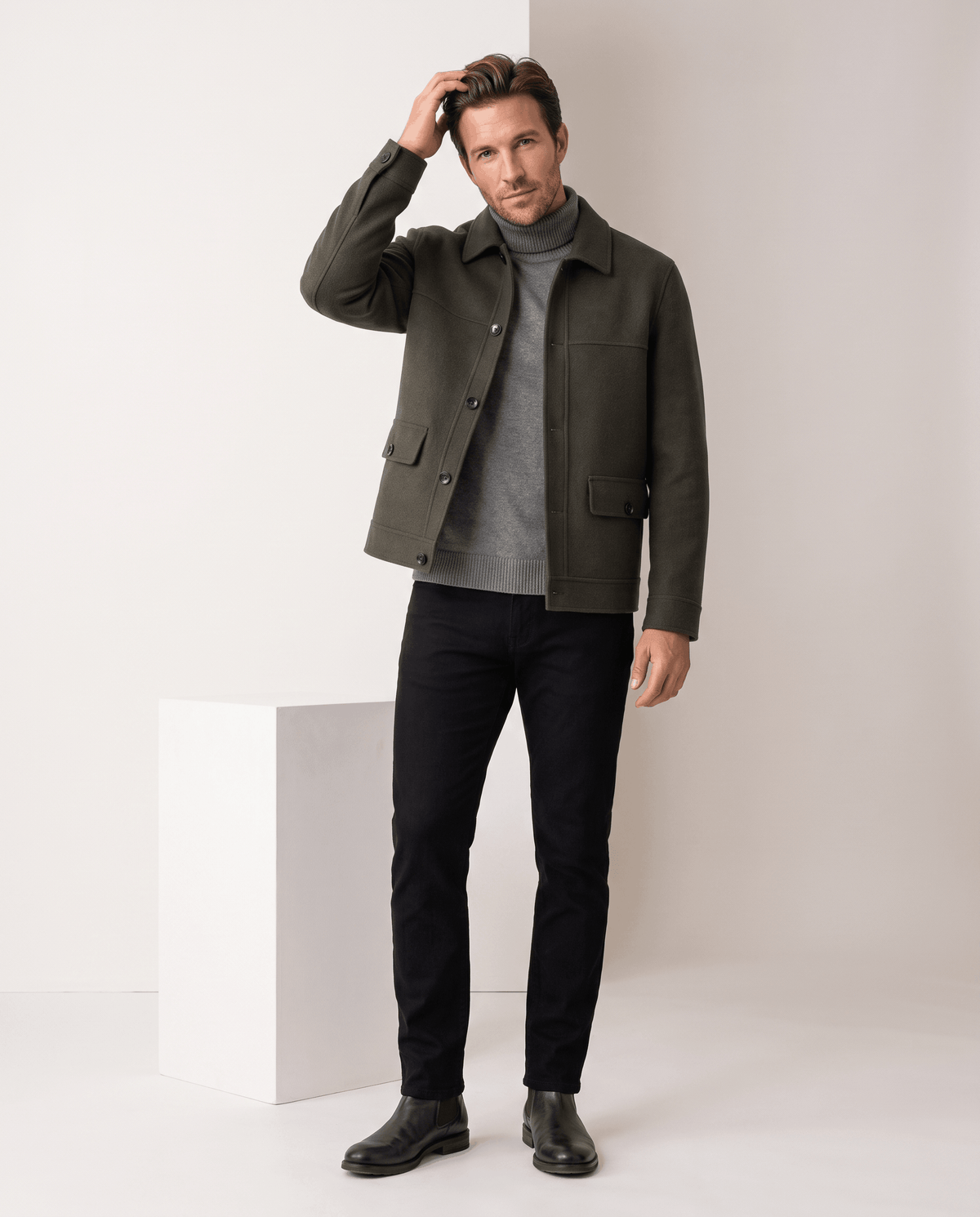 Full-length olive green jacket styled with dark trousers and black derby shoes