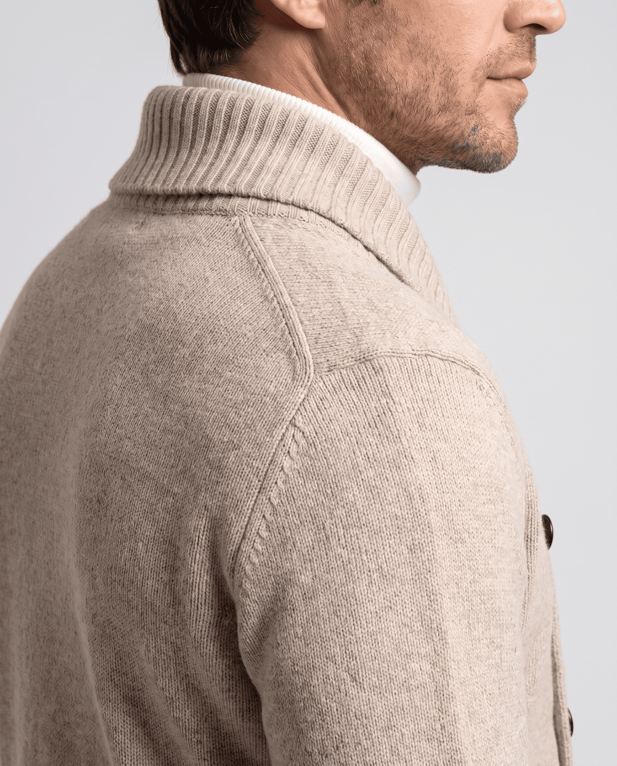 Close back view of beige cardigan shawl collar and shoulder
