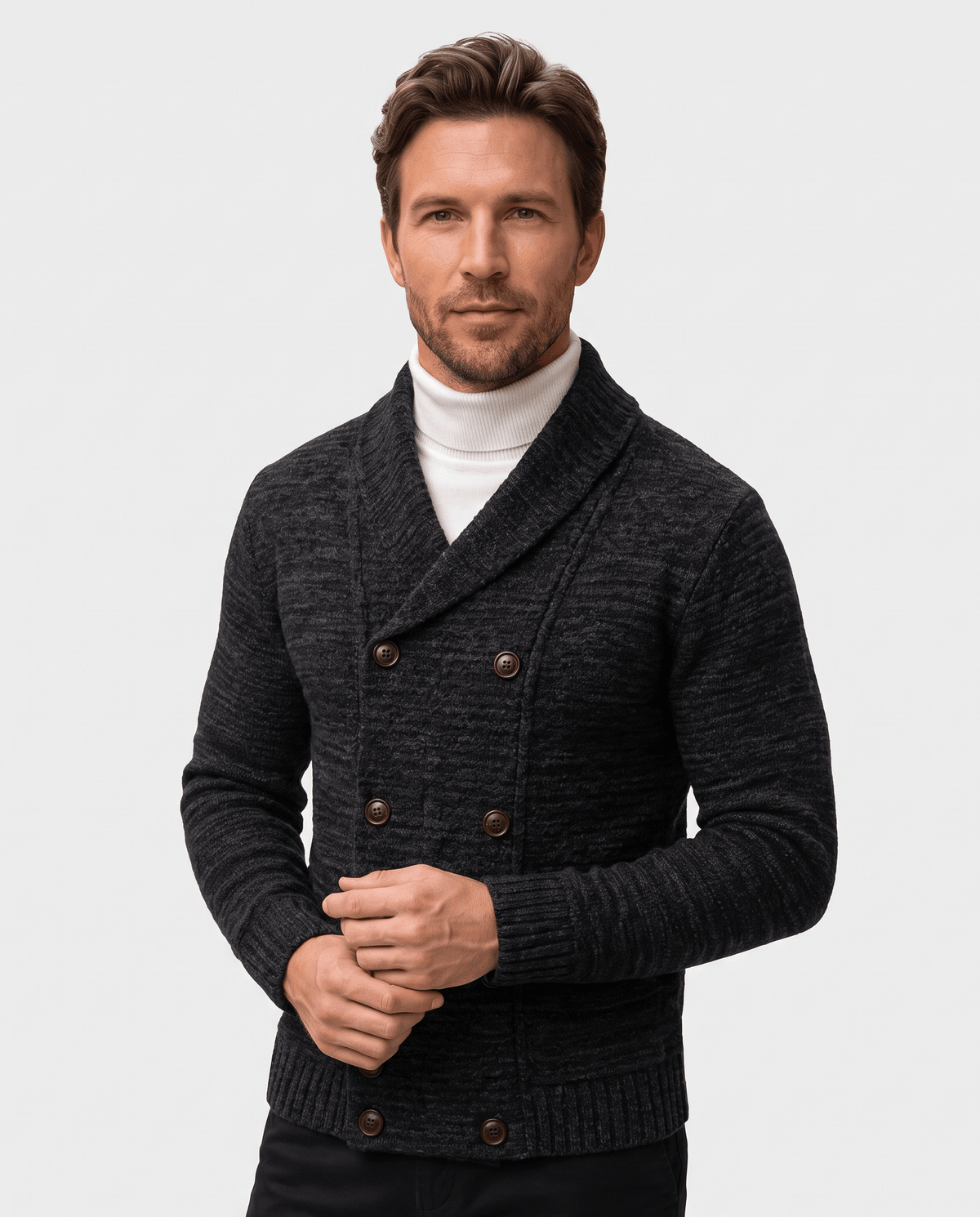 Men's black double-breasted shawl collar cardigan worn over a white turtleneck