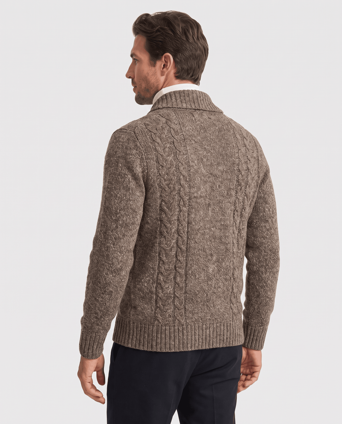 Back view of dark brown textured cardigan worn with dark trousers