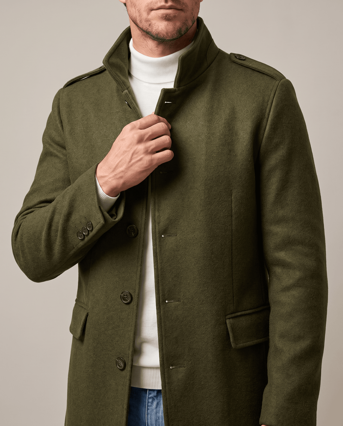 Army green overcoat with a hand at the stand collar and button placket