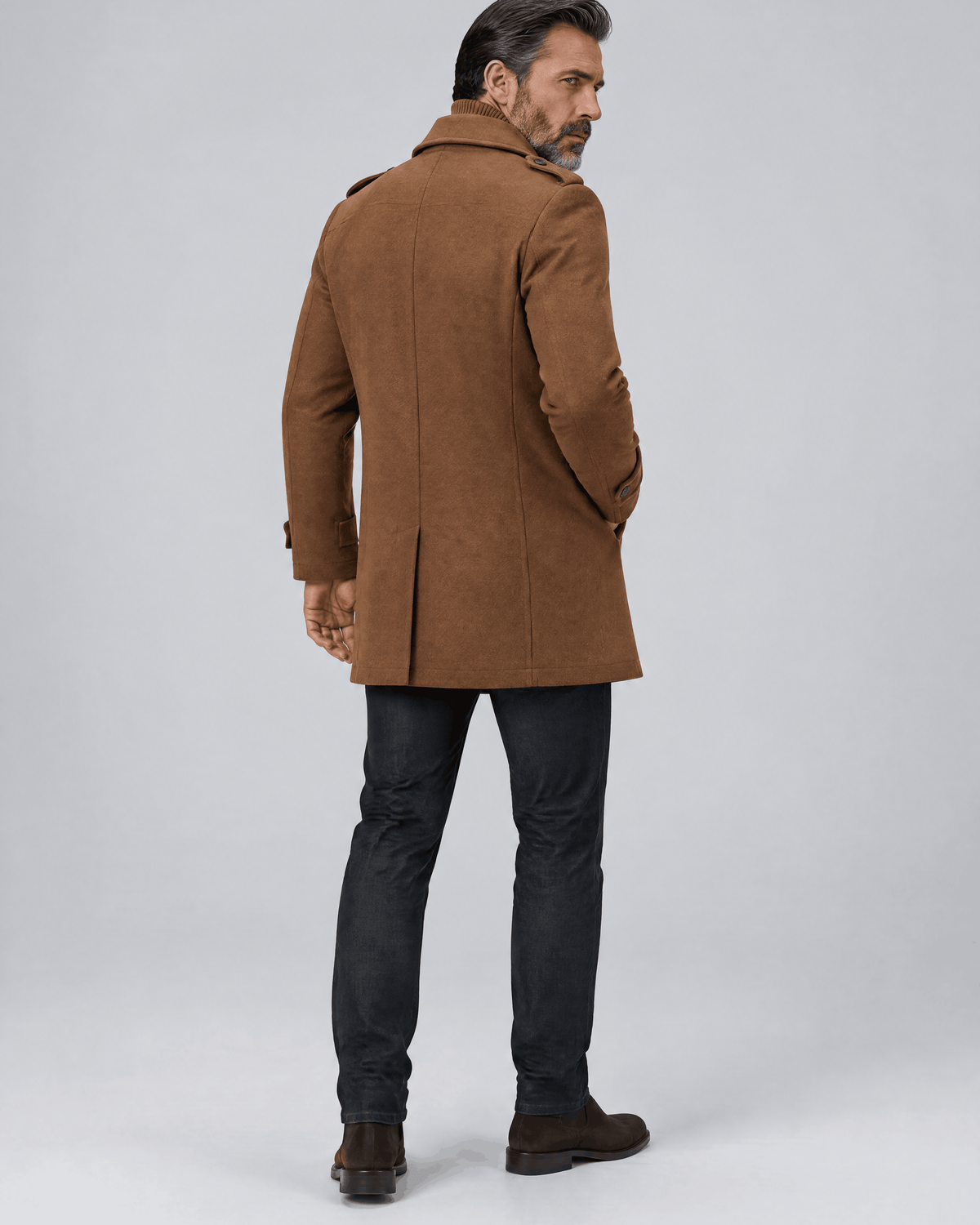 Back of the caramel coat showing a clean back panel and shoulder line over dark trousers