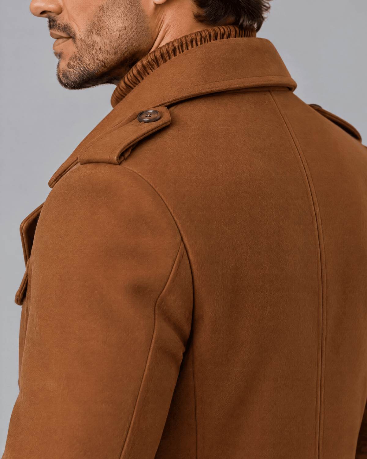 Caramel coat shoulder and collar close-up showing the epaulette and wool blend texture