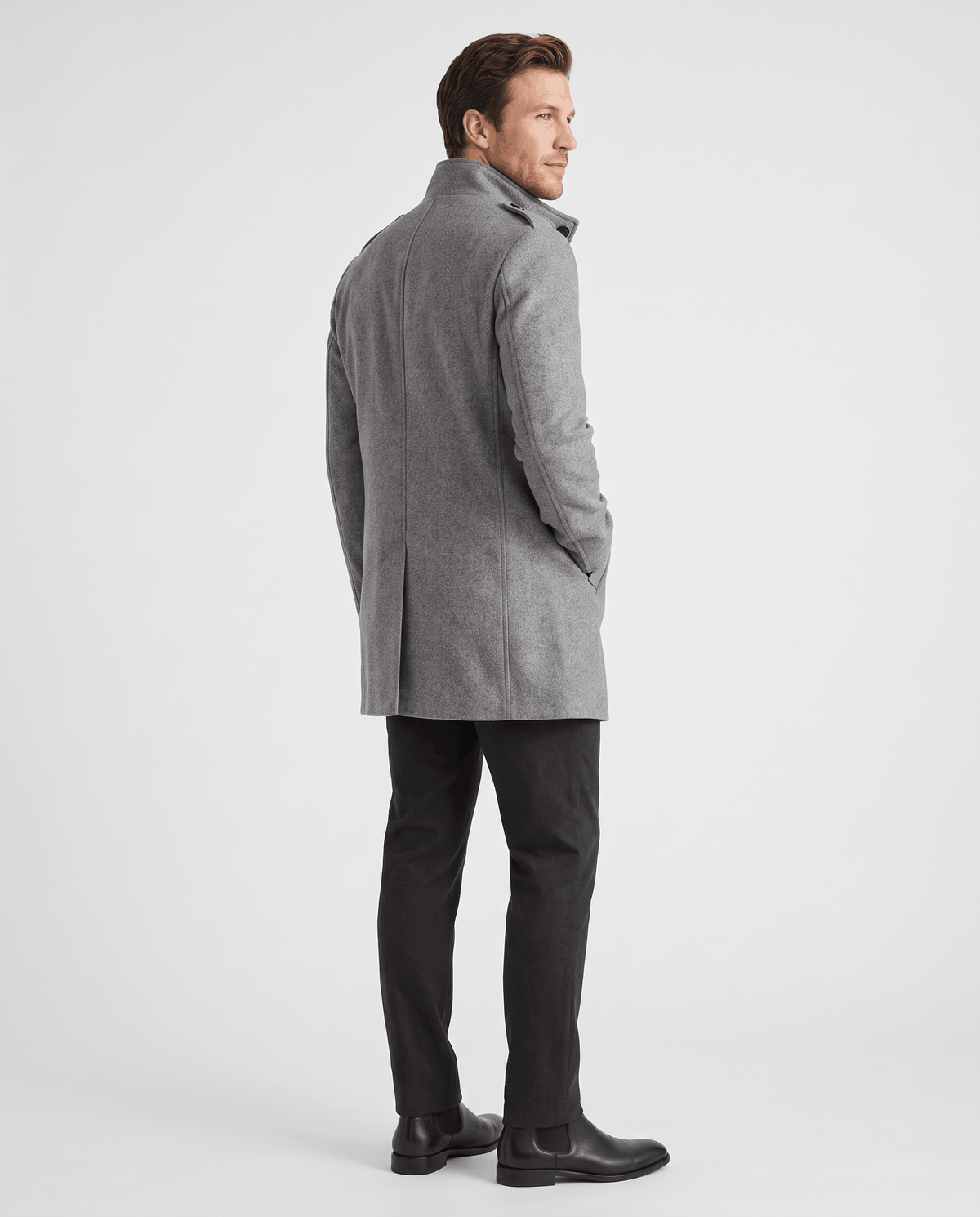 Back view of the gray overcoat worn with dark trousers and black boots